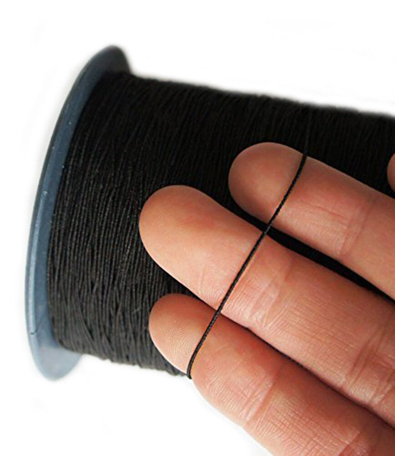 Large roll of black shirring elastic on a white background