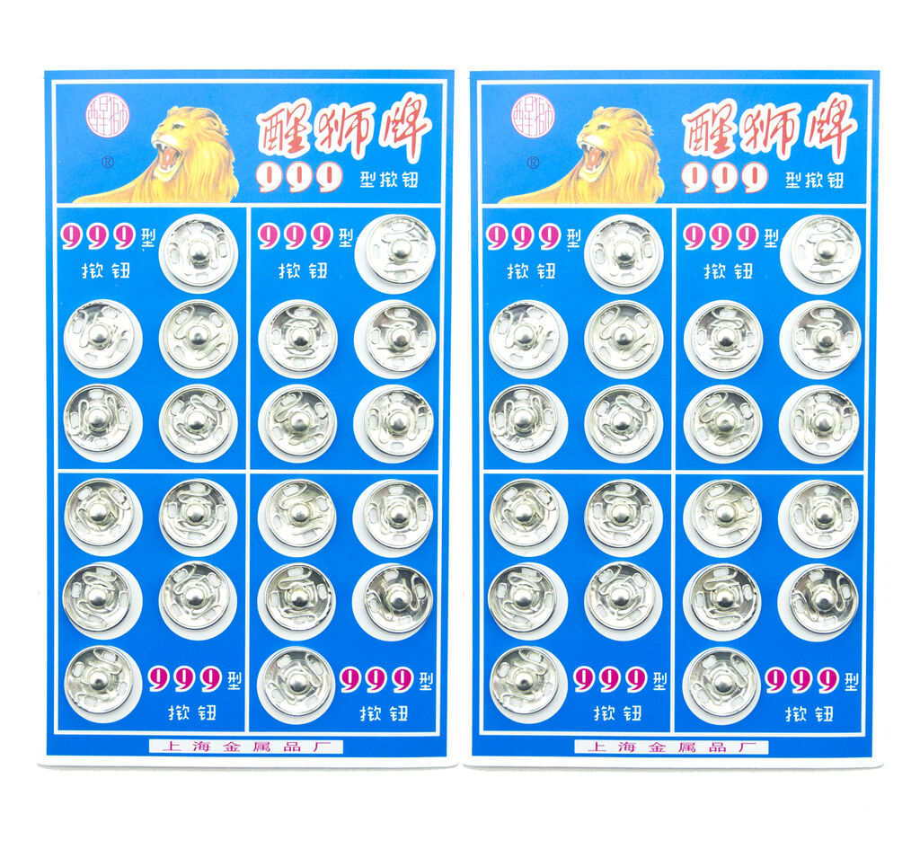 Close-up of silver metal clip buttons for sewing projects.