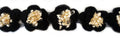 Close-up of decorative black and beige knitted flower trim