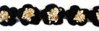 Close-up of decorative black and beige knitted flower trim