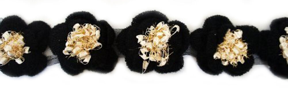 Close-up of decorative black and beige knitted flower trim