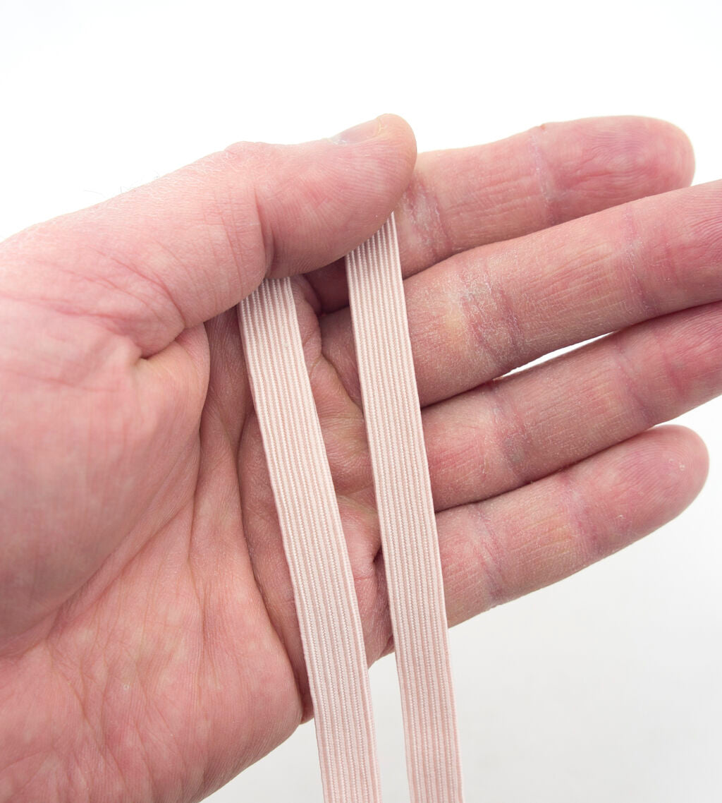 Close-up of extra strength max stretch flat elastic in skin colour.