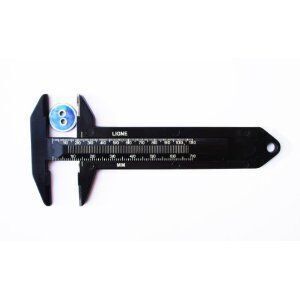 Side view of the black button measurer highlighting its design