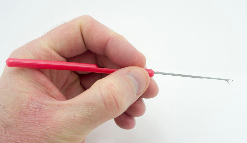 Small thin loop turner in use, turning a fabric tube.