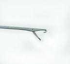 Close-up of a plastic loop turner showing its thin design.