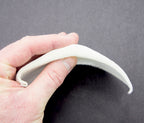 Close-up view of a white children's shoulder pad.