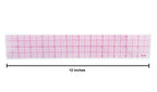 Graph ruler placed on a drafting table with tools.
