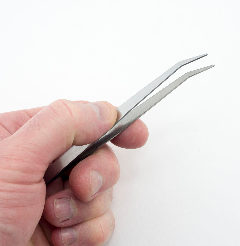 Curved sewing machine tweezers designed for precision and ease of use.