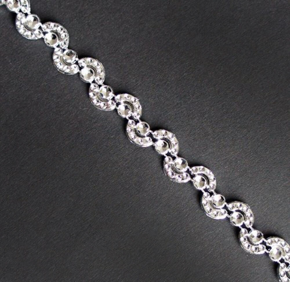 Close-up of Pretty Silver Moon Shape Trims on a white background