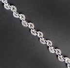 Close-up of Pretty Silver Moon Shape Trims on a white background