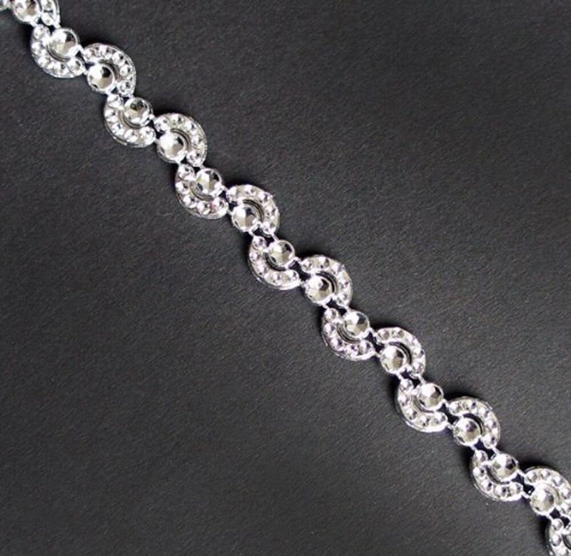 Close-up of Pretty Silver Moon Shape Trims on a white background