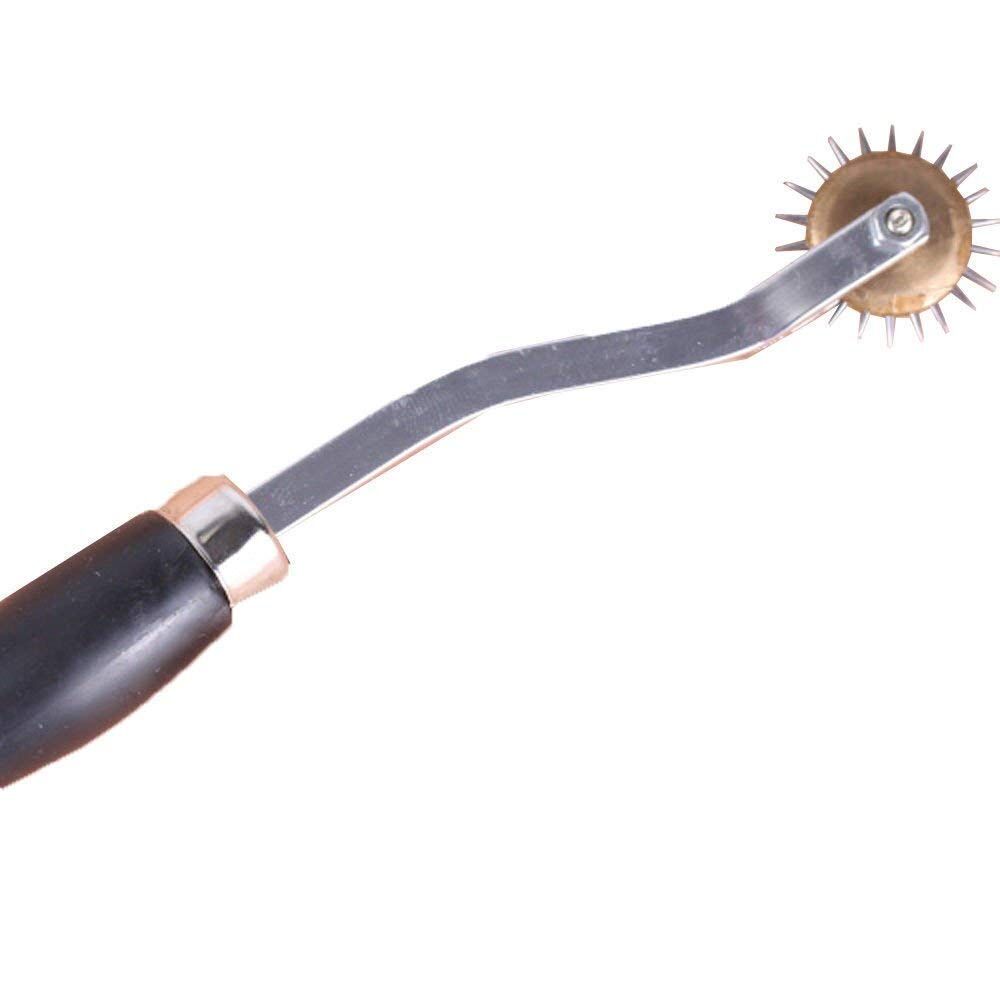 Close-up of the tracing wheel's hardened steel point and plastic handle.
