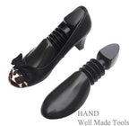 Shoe expanders placed inside a pair of shoes for stretching