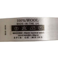 Roll of fabric printed wash care labels for wool garments.