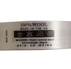 Roll of fabric printed wash care labels for wool garments.
