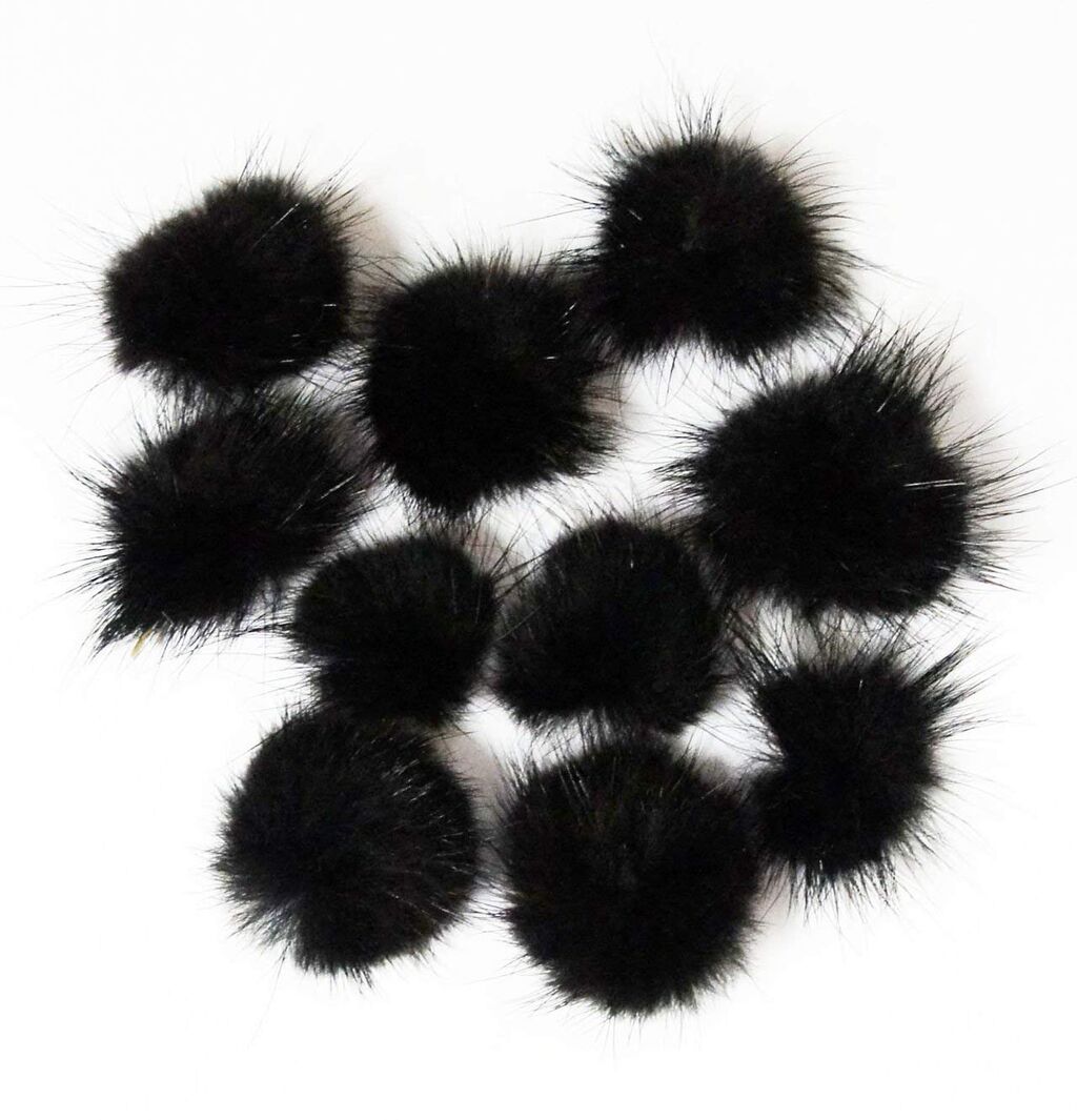 Close-up of black mink pom pom trim showcasing its soft texture.