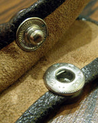 Decorative press studs displayed on a fabric background