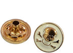 Close-up of 12 mm gold and white skull top snap button