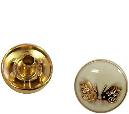 Close-up of a decorative gold and white butterfly press stud