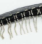 Close-up of the metal beaded fringe on black mesh ribbon.