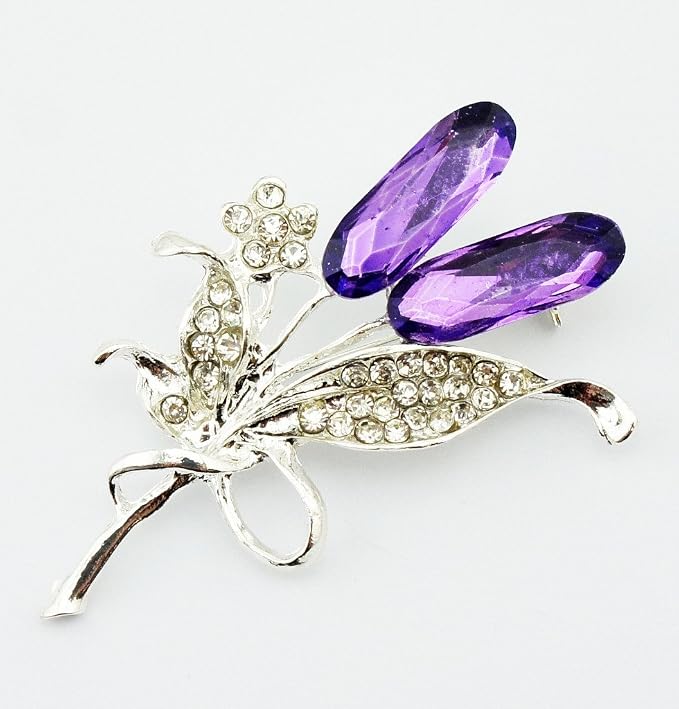 Two brooches showcasing a floral pattern with clear and purple rhinestones.
