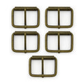 Large antique gold metal belt buckle on a white background.