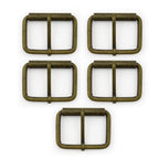Large antique gold metal belt buckle on a white background.