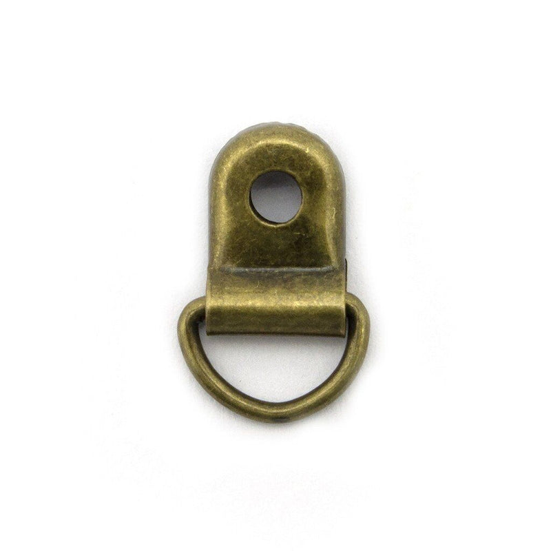 Pack of 20 antique gold metal shoe lace eyelets on display.