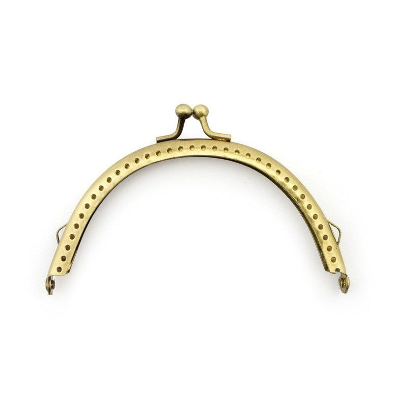 Gold round purse frame with kiss clasp and perforated design.