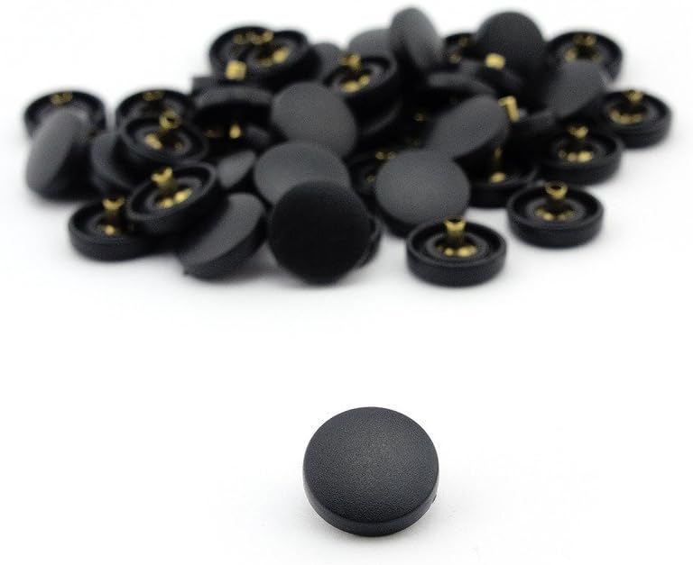 Close-up of a black plastic press stud showing its components.