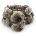 Luxurious soft real rabbit fur scarf in brown with pompom fastening.