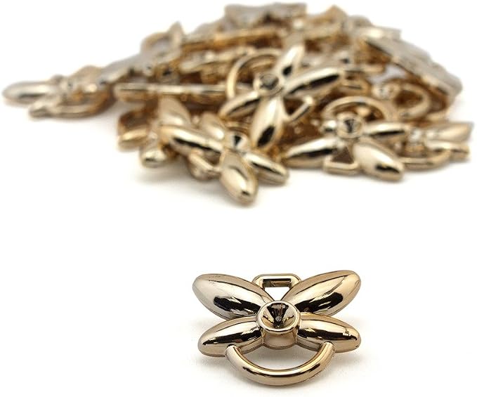 Close-up of a gold colour butterfly double loop trim.