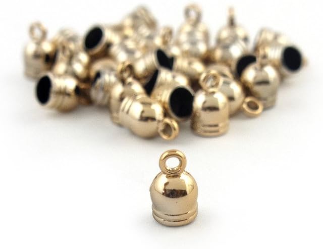 Small gold bell trims displayed on a crafting surface