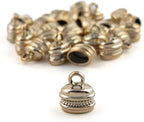 Close-up of a gold colour oval bell shaped trim, 18mm x 11mm.