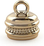 Gold colour oval bell shaped trims arranged for crafting projects.