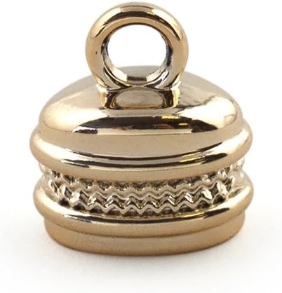 Gold colour oval bell shaped trims arranged for crafting projects.