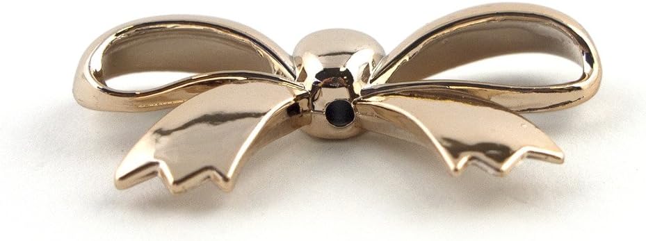 Gold bow shaped trims used on a dress for embellishment.