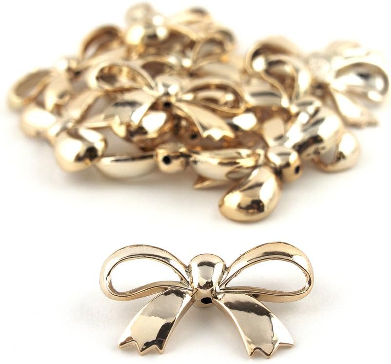 Close-up of the gold bow shaped embellishment showing detail.