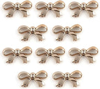 Pack of 20 gold colour bow shaped trims for embellishment.