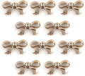 Large gold colour bow shaped trim on a white background.