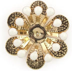 Close-up of the brass and white enamel flower trim showing details.