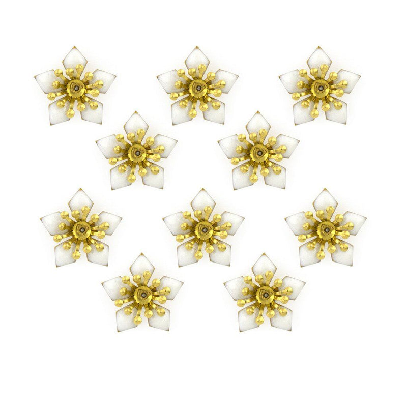 Close-up of white enamel and brass flower sew-on trim