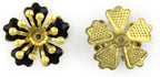 Close-up of black enamel and brass flower embellishment.