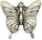 Butterfly pendants displayed on a crafting surface