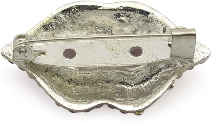 Two red lips brooches displayed together with a soft focus background