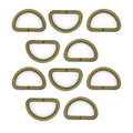 Antique brass D ring buckle on a white background