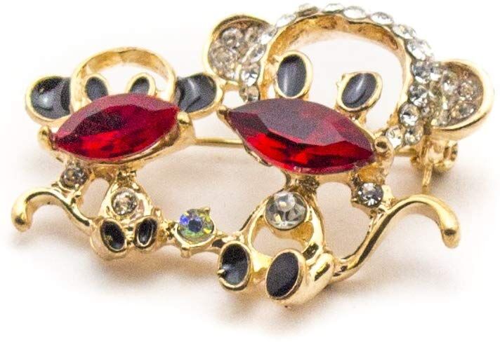 Two cute monkeys brooch with red and white crystals in gold frame.
