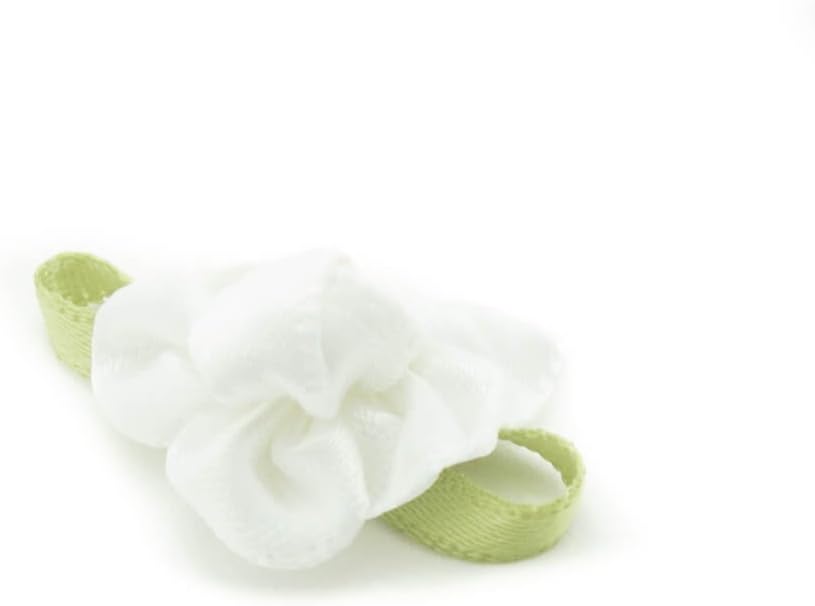 Close-up of white ribbon bow trim with fabric flower and bud detail.