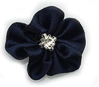 Satin ribbon and diamante flower trim sewn onto a fabric swatch