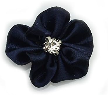 Satin ribbon and diamante flower trim sewn onto a fabric swatch